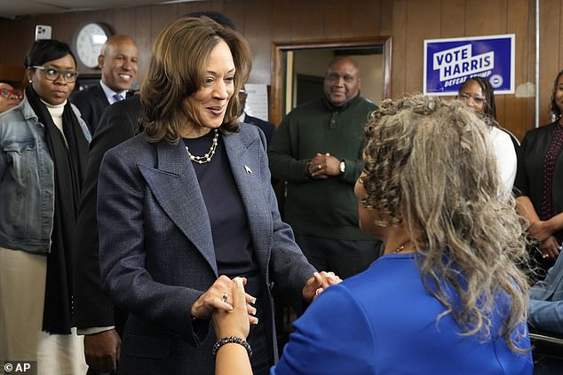 Democratic presidential candidate Vice President Kamala Harris (left) greets Martha Roland, mother of Elam's barbershop Roland Elam Jr., as others look on before participating in a roundtable discussion with local leaders at Elam's barbershop in Pontiac, Michigan, Sunday. November 3, 2024