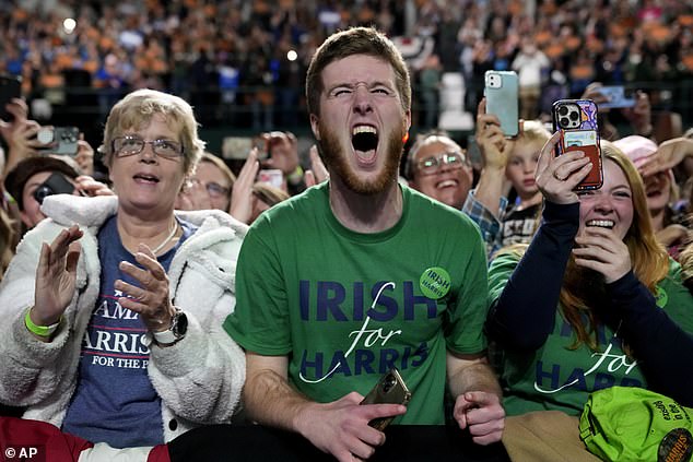 Supporters react as Democratic presidential candidate Vice President Kamala Harris speaks during a campaign rally at Jenison Field House