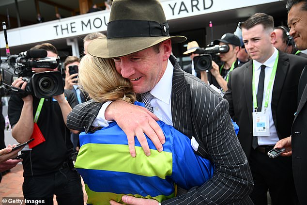 Ciaron Maher (pictured hugging jockey Jamie Kah after a win) has four runners in the 2024 Melbourne Cup