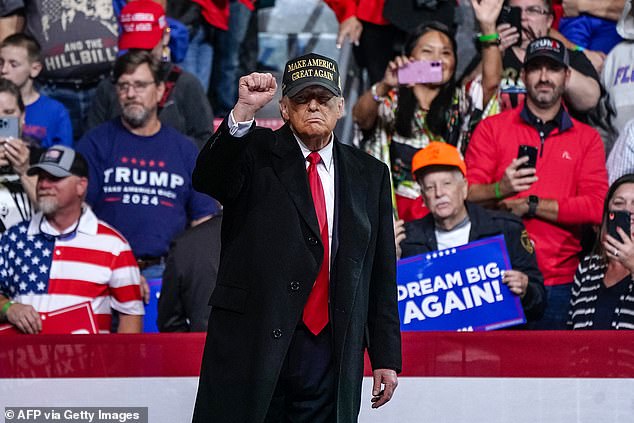 Trump clenches his fist after delivering a speech at the end of a campaign rally in Macon, Georgia, on Sunday evening