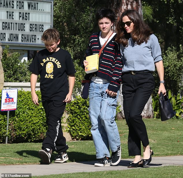 Jennifer looked casual and stylish in a gray turtleneck with black trousers and slingback heels, while Fin wore a red, white and blue cardigan with cargo jeans and Sameul went casual in black.