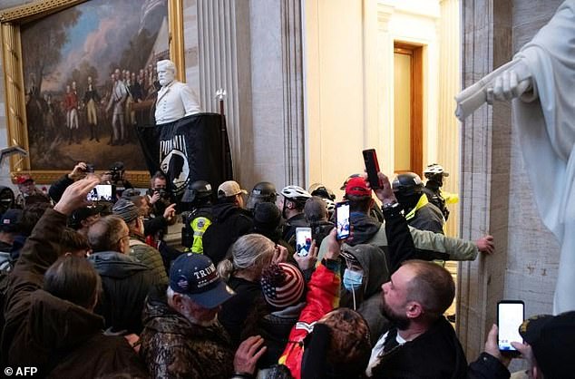 Donald Trump supporters are confronted by police at the US Capitol during a protest aimed at stopping the transfer of power to Joe Biden, on January 6, 2021