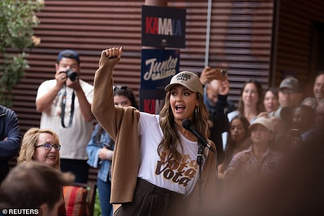 Alba looked optimistically at the microphone at the event in a white 