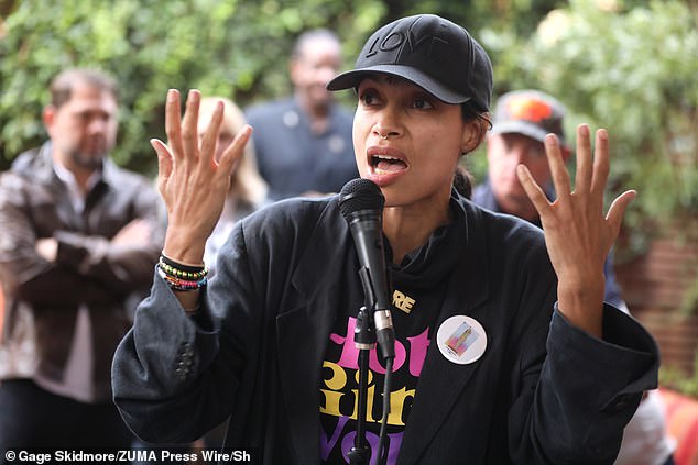 Rosario Dawson was a master of casual-cool style with her thick black sport coat, which she wore over a black shirt. She wore her hair in a ponytail and wore a black 'Love' baseball cap, and she sported a chic septum piercing.