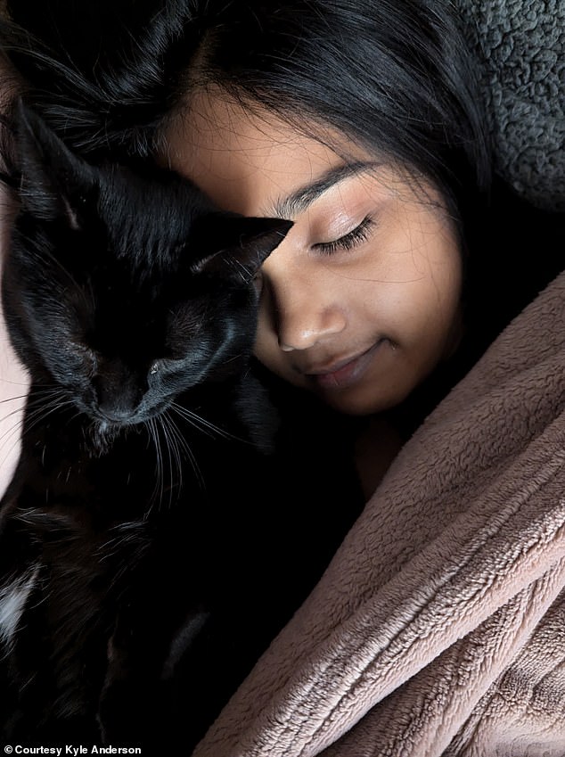 Anderson's fiancée, Vidhi, with one of their seven cats, named Beelzebub