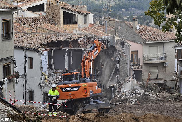 A look at demolition work on a damaged house after flash flooding in Letur, Albacete province, Spain