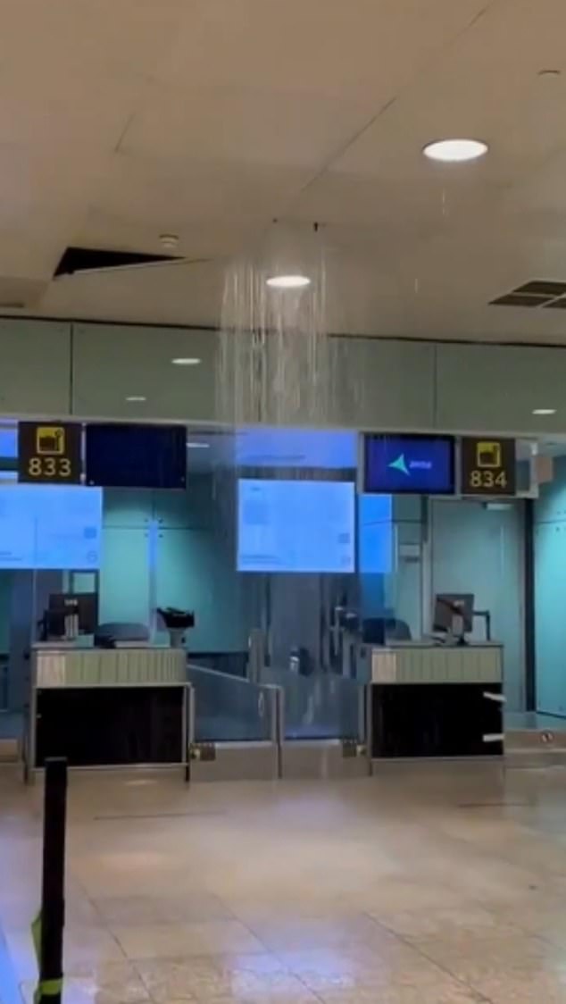 Water flows from the ceiling of El Prat airport, where flights have been diverted due to the deluge