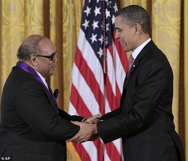 President Barack Obama presents a National Medal of Arts to Quincy Jones at the White House in March 2011