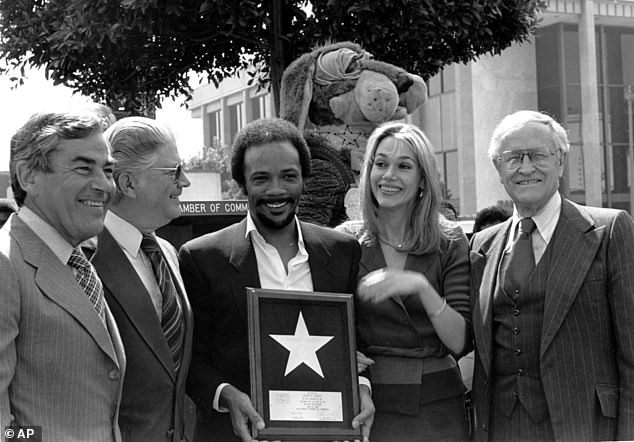 Quincy Jones and his wife Peggy Lipton hold Jones' star, which was placed on the Hollywood Walk of Fame in Los Angeles in March 1980