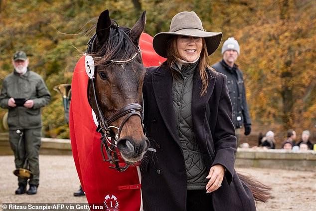 The mother of four couldn't hide her excitement as she beamed as she stroked the brunette pony and posed for photos