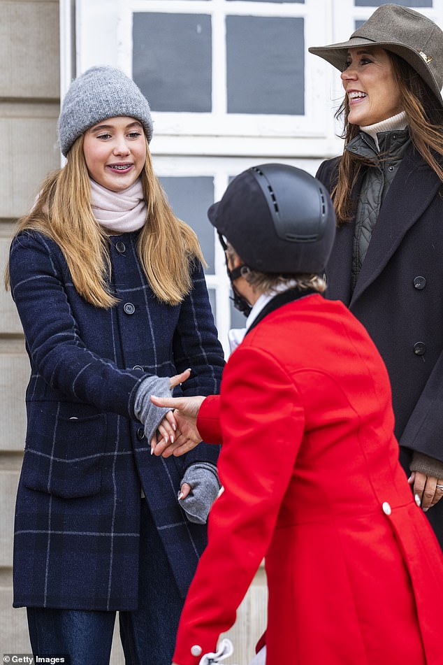 Princess Josephine is shown shaking hands with one of the riders