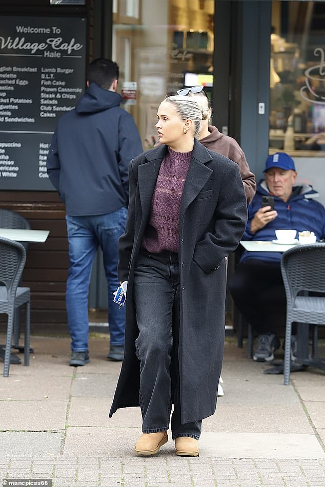 The reality star, 25, who just launched her own clothing line Maebe, wore an oversized black coat over a purple sweater