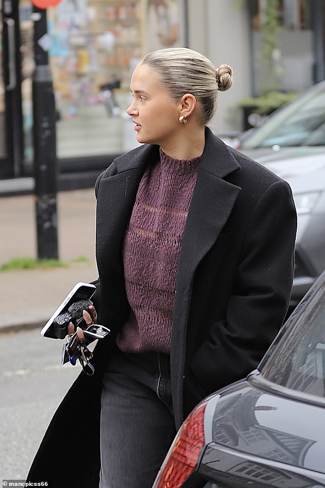 Molly-Mae pulled her hair back into a bun and wore minimal makeup, pairing the look with dark jeans and Ugg boots