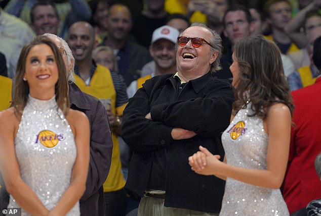 Nicholson laughs at former Los Angeles Lakers center Shaquille O'Neal as they pull back his jersey during halftime of the Lakers' NBA basketball game against the Dallas Mavericks in 2013