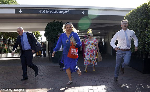 MELBOURNE, AUSTRALIA - NOVEMBER 05: Racegoers arrive during Melbourne Cup Day at Flemington Racecourse on November 5, 2024 in Melbourne, Australia. (Photo by Daniel Pockett/Getty Images)