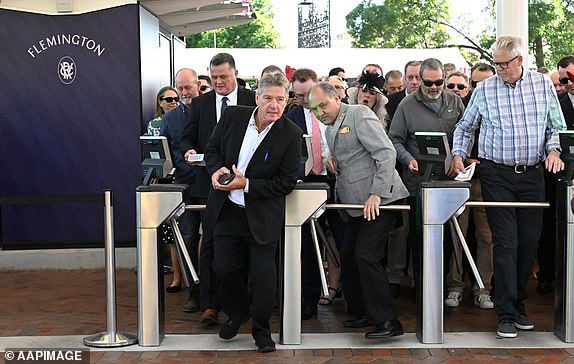 Racegoers line up at the gates ahead of the 2024 Melbourne Cup at Flemington Racecourse in Melbourne, Tuesday, November 5, 2024. (AAP Image/James Ross) NO ARCHIVING, EDITORIAL USE ONLY