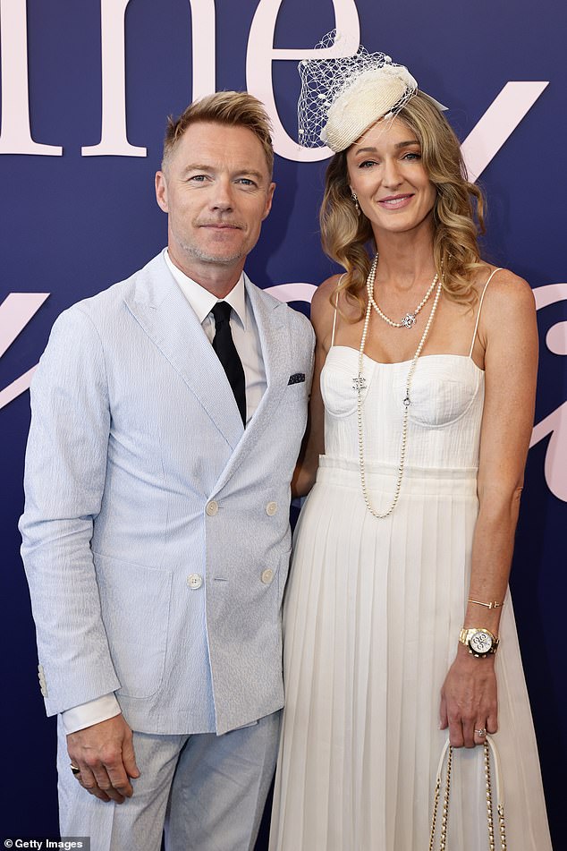 Ronan's appearance at the Melbourne Cup comes after he confirmed he has moved to Australia with his family (pictured with wife Storm)