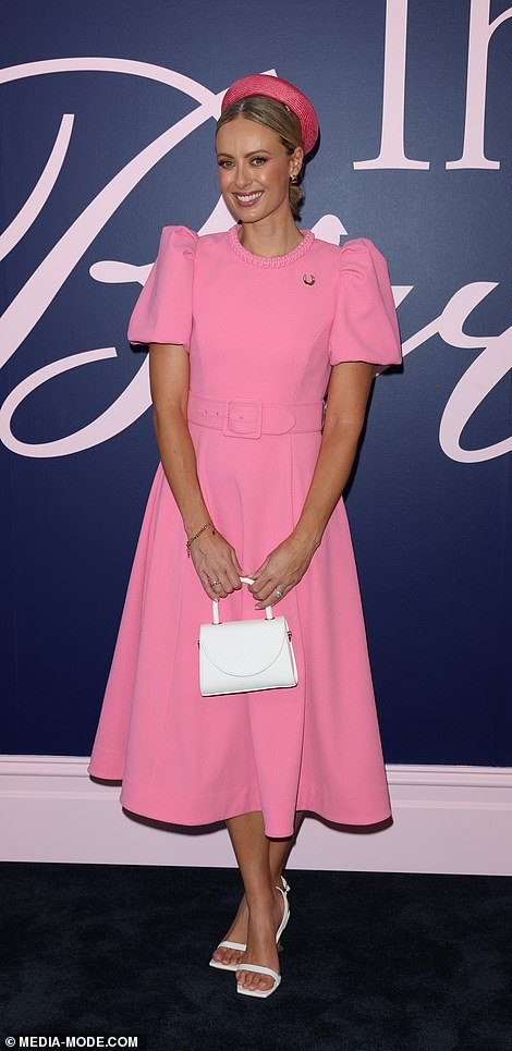 Today Show host Sylvia Jeffreys was pretty in pink, wearing a tea-length Rebecca Vallance dress that hugged her waist with a fabric belt