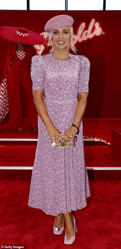 Television presenter and radio presenter Jacqueline Felgate wore an ankle-length patterned mauve dress with a beret and a mesh net