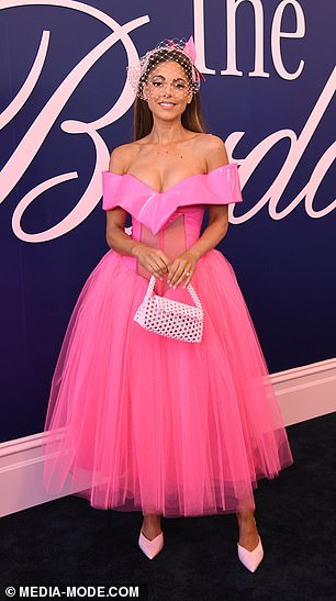 She paired the look with white heels, a handbag and minimal jewelry