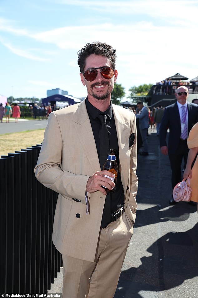 Brad, meanwhile, kept it classic yet edgy in a beige suit jacket, black shirt and matching trousers, complete with aviator sunglasses