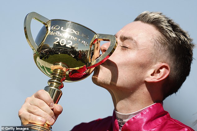 Jockey Robbie Dolan kissing the trophy after winning the 2024 Melbourne Cup on Knight's Choice