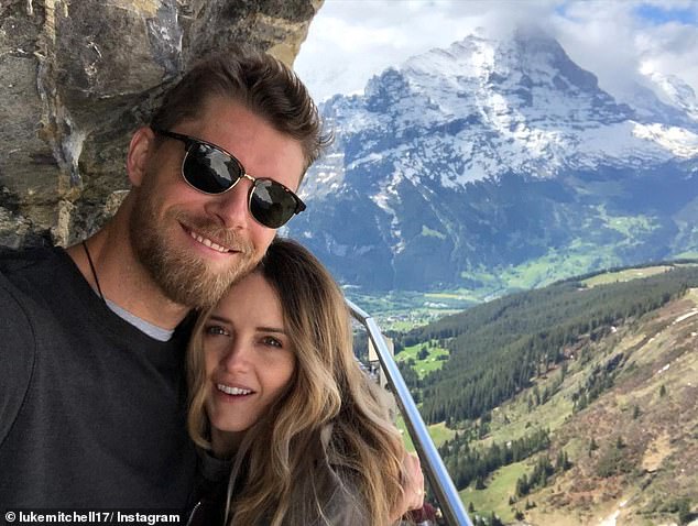 The actress shared a photo on Instagram on Tuesday showing her happily cradling her growing baby bump on the red carpet at the Adelaide Film Festival. Rebecca is pictured with her husband Luke Mitchell.