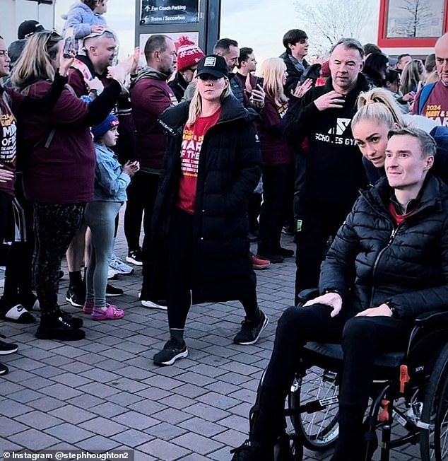 Houghton pushes ex-footballer Darby in his wheelchair as they arrive at Anfield to complete the giant walk as they raise awareness of MND, from which he suffers