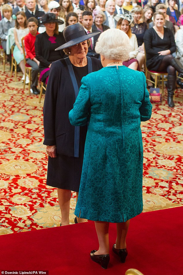 Dame Maggie Smith is appointed to the Order of the Companions of Honor by Queen Elizabeth II during an investiture ceremony at Windsor Castle on October 17, 2014