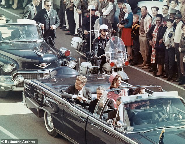 US President John F Kennedy, First Lady Jacqueline Kennedy, Texas Governor John Connally and others smile at the crowd along their motorcade route in Dallas, Texas, on November 22, 1963. Minutes later, the president was assassinated as his car drove through Dealey Plaza .