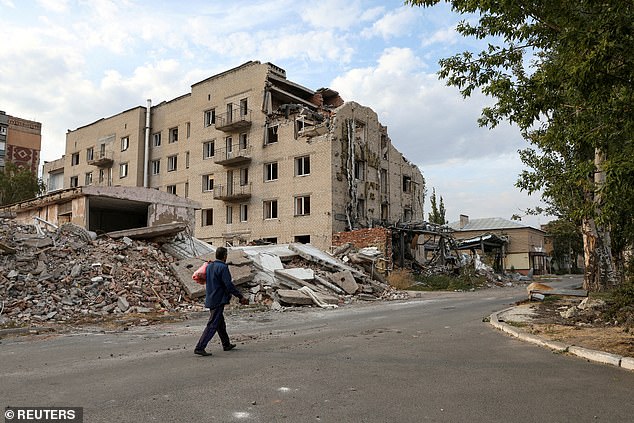 A man walks past a building damaged by a Russian military attack in the city of Pokrovsk, amid the Russian attack on Ukraine, Donetsk region