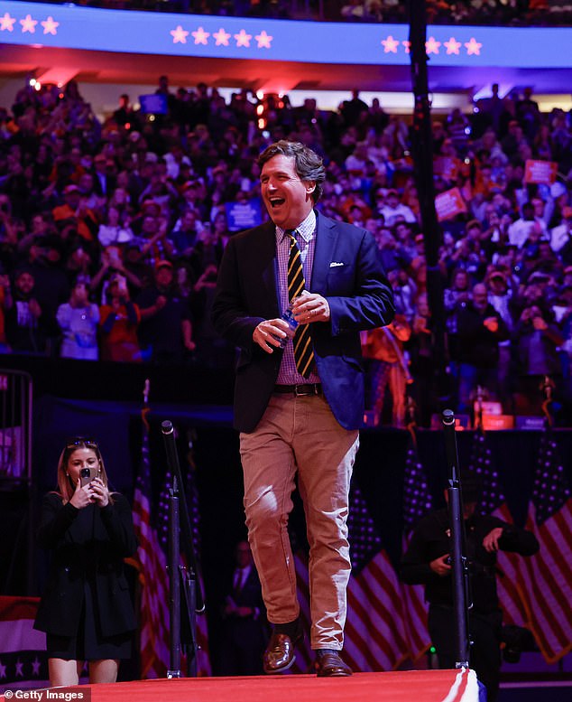 Carlson, pictured at Trump's rally at Madison Square Garden on October 27, took his wild comments even further by dismissing scientific evidence that attributes climate change to hurricanes and instead claimed that the natural disasters were 'probably' caused by ' abortion'.