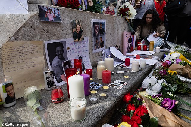 Flowers, photos and candles are displayed in honor of Liam Payne during a memorial event in Santa Ana Square on October 20, 2024 in Madrid, Spain