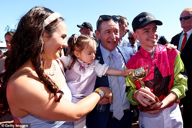 Dolan (pictured with his wife, daughter and father after winning the Cup) moved to Australia in 2016 looking for a fresh start due to a lack of opportunities as an apprentice jockey in Ireland