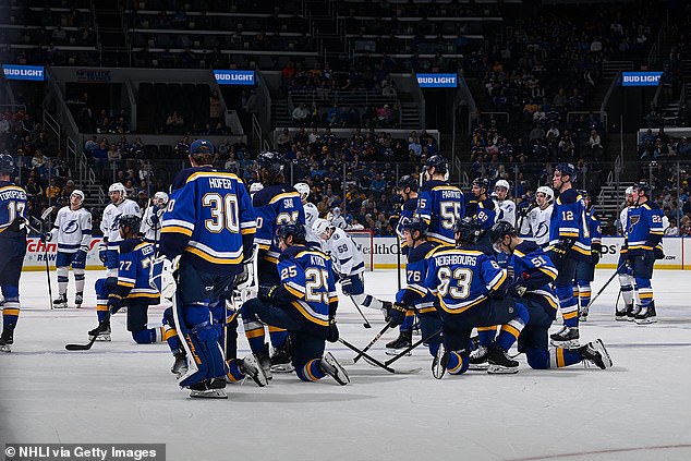 Players knelt on the ice as medics tended to Holloway before he was taken to hospital