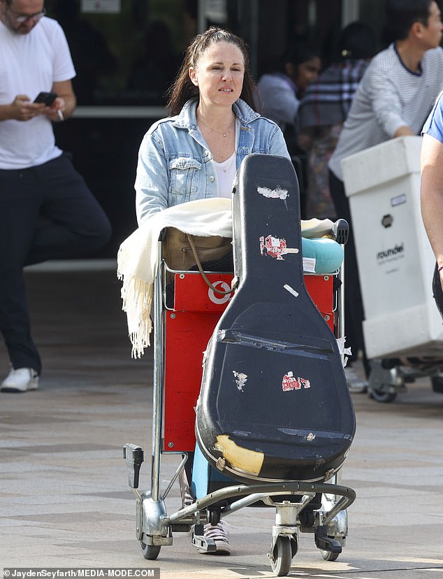 The Scottish singer had her hands full driving a cart full of a suitcase and a large guitar case