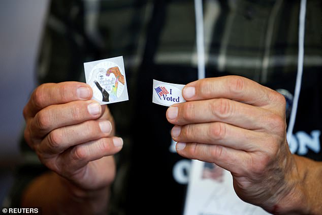 n election worker shows "I voted" stickers, during the 2024 United States presidential election on Election Day in Arden, North Carolina