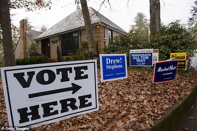 Voting signs direct people to Biltmore Forest City Hall on November 5, 2024 in Asheville, North Carolina