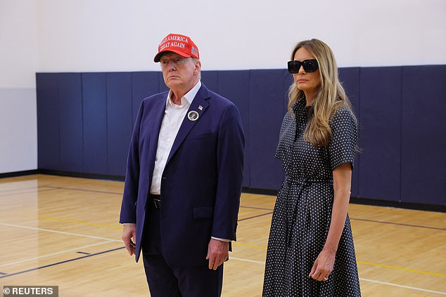 Republican presidential candidate and former US President Donald Trump, accompanied by former US first lady Melania Trump, speaks to reporters after voting at the Mandel Recreation Center on Election Day in Palm Beach, Florida