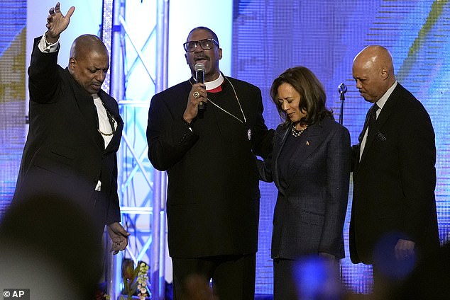 Bishop John Drew Sheard, center left, leads a congregation in a prayer for Democratic presidential candidate Vice President Kamala Harris, center right, during a church service at the Greater Emmanuel Institutional Church of God in Christ, Sunday, Nov. 3, 2024, in Detroit. Harris hoped for a goose-black turnout in the final days of the race