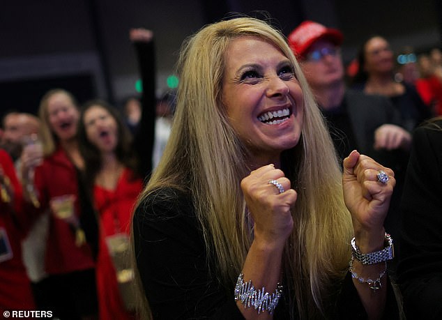 A supporter of Republican presidential candidate and former US President Donald Trump reacts as he watches the early results at the Trump election night site