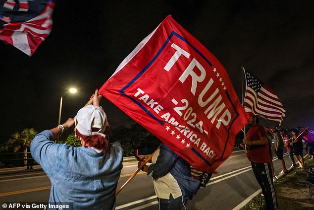 Trump supporters wave MAGA flags near his Mar-a-Lago resort in Palm Beach, Florida