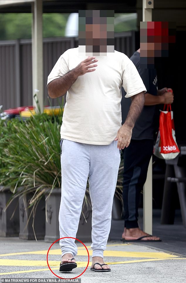 The photo shows a former detainee wearing an ankle monitor who was released following last year's Supreme Court ruling that indefinite detention is unlawful