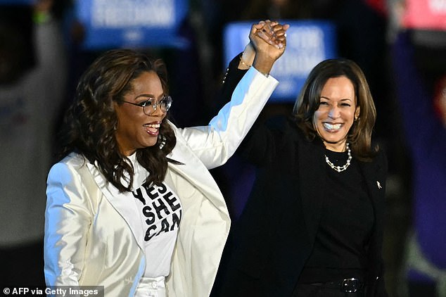 Kamala Harris stands hand-in-hand with Oprah Winfrey in her final rally of the presidential election, with just hours until the first polls open