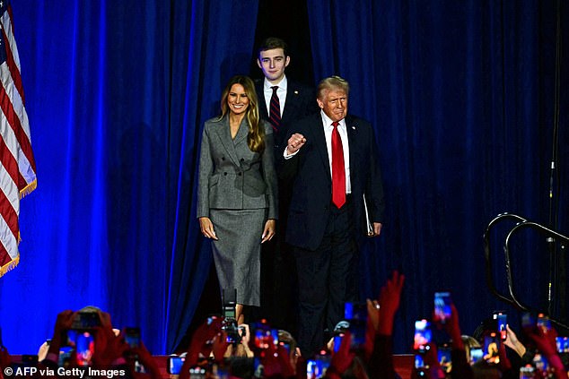 Donald Trump arrives on his election night with his smiling wife Melania and their 18-year-old son Barron by his side