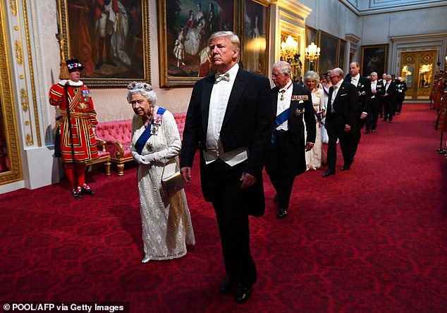 Queen Elizabeth II walks with Donald Trump at Buckingham Palace for the 2019 banquet