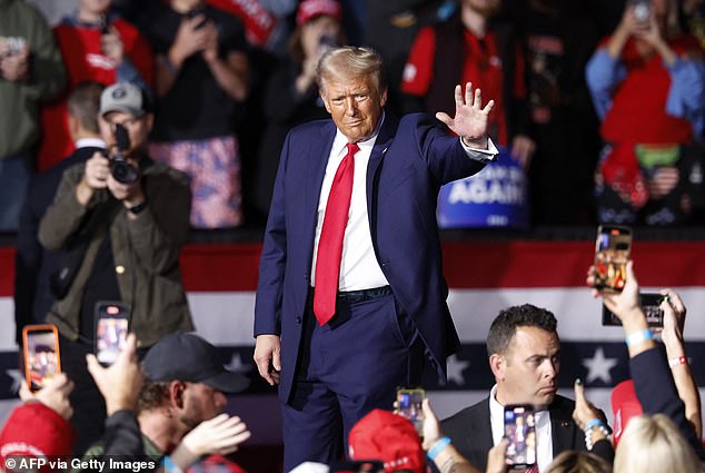 Former US president and Republican presidential candidate Donald Trump waves to supporters at the end of a campaign rally, November 5