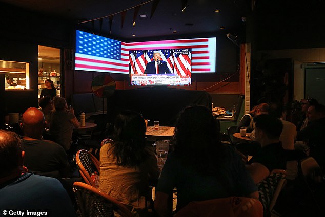 Pubgoers in Sydney watched the results trickle in, with some crying as Trump gained traction in the polls (photo, election livestream audience at Sydney's Kent Street Hotel)