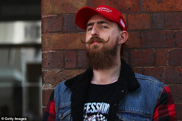 In his victory speech, Trump said: 'We made history tonight for a reason, and the reason is because we overcame obstacles that no one thought possible' (pictured, a Trump supporter in Sydney)