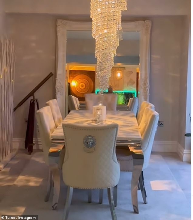 Builders had installed a huge cascading chandelier above the six-seat dining table, which stood in front of a mirror and took up almost the entire back wall